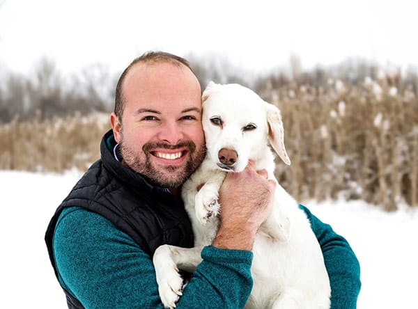 A person holding a white dog